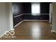 Spacious dining room with hardwood floors and dark purple walls at 810 Kendale Ct, Indianapolis, IN 46234