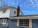 Side exterior view, showcasing the home's brick details, contrasting trim, and complementing shutters at 810 Kendale Ct, Indianapolis, IN 46234