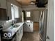 Modern kitchen with white cabinets, quartz countertops, and stainless steel appliances at 810 Kendale Ct, Indianapolis, IN 46234