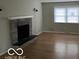 Living room with hardwood floors and a stone fireplace at 810 Kendale Ct, Indianapolis, IN 46234