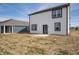 A home's backyard featuring a patio, neutral siding and trim, and a blue-sided neighbor at 8798 Walker St, Fortville, IN 46040