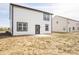The home's backyard boasts a black-trimmed door, patio area and space for the lawn at 8798 Walker St, Fortville, IN 46040