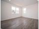 Bedroom featuring light gray wood-look floors, white walls, and natural light at 8798 Walker St, Fortville, IN 46040