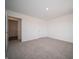 Cozy bedroom featuring plush carpet, fresh walls, and an open doorway to another room at 8798 Walker St, Fortville, IN 46040