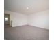Bright bedroom featuring neutral carpet, white walls, and access to other rooms in the house at 8798 Walker St, Fortville, IN 46040