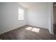 Bedroom featuring light gray wood-look floors, white walls, baseboards, and trim at 8798 Walker St, Fortville, IN 46040
