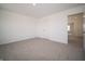 Bedroom with neutral carpet and walls, featuring a large window and closet at 8798 Walker St, Fortville, IN 46040