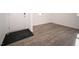 Entryway with a white front door, dark floor mat, and light gray wood-look floors at 8798 Walker St, Fortville, IN 46040