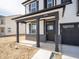 Covered front porch with black columns, brick accents, and a glass-paneled front door at 8798 Walker St, Fortville, IN 46040