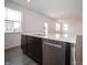 The well-lit kitchen island, complete with a stainless steel dishwasher, is the focal point of this functional layout at 8798 Walker St, Fortville, IN 46040