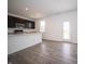 Modern kitchen featuring a large island, stainless appliances, and dark cabinetry at 8798 Walker St, Fortville, IN 46040