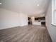 Bright living room with wood floors and open concept to the kitchen with recessed lighting and modern design at 8798 Walker St, Fortville, IN 46040