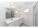 Spacious bathroom featuring double sinks, ample counter space, and glass shower at 9217 Hawley Dr, Indianapolis, IN 46216