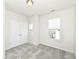 Well-lit bedroom features gray carpet, double door closet, and a window with blinds at 9217 Hawley Dr, Indianapolis, IN 46216