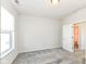 Bedroom with gray carpet, view of bathroom through doorway, and a window with blinds at 9217 Hawley Dr, Indianapolis, IN 46216