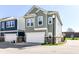 Charming two-story home features a two-car garage and manicured lawn with a light blue facade at 9217 Hawley Dr, Indianapolis, IN 46216