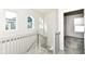 Upstairs hallway features gray and white railings, carpeted stairs, and natural light at 9217 Hawley Dr, Indianapolis, IN 46216