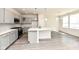 Modern kitchen featuring gray cabinets, an island with a sink, stainless steel appliances, and pendant lighting at 9217 Hawley Dr, Indianapolis, IN 46216