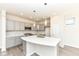 Elegant kitchen with an island, stainless steel appliances, gray cabinetry, modern lighting, and hardwood floors at 9217 Hawley Dr, Indianapolis, IN 46216