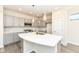 Well-equipped kitchen with gray cabinetry, hardwood floors, an island with sink, and stainless steel appliances at 9217 Hawley Dr, Indianapolis, IN 46216