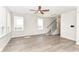 Spacious living room showcasing hardwood floors, a ceiling fan, neutral walls, and an open staircase at 9217 Hawley Dr, Indianapolis, IN 46216