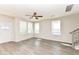 Bright living room with hardwood floors, large windows, neutral walls, and a modern ceiling fan at 9217 Hawley Dr, Indianapolis, IN 46216