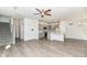 Open-concept living space flowing into the kitchen with hardwood floors and an open staircase at 9217 Hawley Dr, Indianapolis, IN 46216