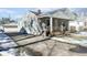 Gray house with wooden porch and driveway; some snow is visible at 1108 Rosner Dr, Indianapolis, IN 46224