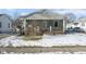 Gray house with wooden porch, front yard, and snow on the ground at 1108 Rosner Dr, Indianapolis, IN 46224