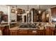 Large kitchen island with granite top and cooktop at 11281 Golden Bear Way, Noblesville, IN 46060