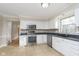 Modern kitchen with stainless steel appliances and white cabinets at 11421 Haverstick Rd, Carmel, IN 46033