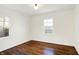 Simple bedroom with hardwood floors and a window at 1248 Dequincy St, Indianapolis, IN 46201