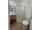 Clean bathroom with corner shower and wood-look floors at 1256 Kappes St, Indianapolis, IN 46221