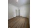 Spacious bedroom with wood-look floors and two doors at 1256 Kappes St, Indianapolis, IN 46221