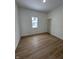 Bright bedroom with window and wood-look floors at 1256 Kappes St, Indianapolis, IN 46221