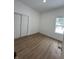 Spacious bedroom with wood-look floors and sliding doors at 1256 Kappes St, Indianapolis, IN 46221
