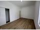 Bedroom with wood-look floors, closet, and door at 1256 Kappes St, Indianapolis, IN 46221