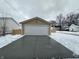 Tan garage with white door and a concrete driveway at 1256 Kappes St, Indianapolis, IN 46221