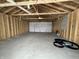 New garage interior with concrete floor and overhead door at 1256 Kappes St, Indianapolis, IN 46221