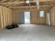 Unfinished garage interior with concrete floor and open framing at 1256 Kappes St, Indianapolis, IN 46221