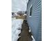 Side view of blue house, snow-covered yard, and wooden fence at 1256 Kappes St, Indianapolis, IN 46221