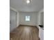 Bright living room with vinyl flooring and an exterior door at 1256 Kappes St, Indianapolis, IN 46221