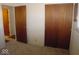 Bedroom featuring neutral walls, carpet, and double doors at 1256 N Eaton Ave, Indianapolis, IN 46219