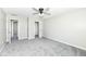 Bedroom with grey carpet, ceiling fan, and access to closets at 12873 Longleaf Ln, Fishers, IN 46038