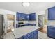 Modern kitchen with blue cabinets, white quartz countertops, and stainless steel appliances at 138 Fairway Dr, Indianapolis, IN 46260