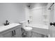 Modern bathroom with white tub/shower, gray vanity and black fixtures at 1384 Cross St, Martinsville, IN 46151