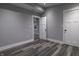 Spacious bedroom with grey walls, white doors and wood-look flooring at 1384 Cross St, Martinsville, IN 46151