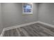 Bright bedroom with grey walls, a window, and wood-look flooring at 1384 Cross St, Martinsville, IN 46151