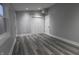 Light and airy bedroom with grey walls, double doors and wood-look flooring at 1384 Cross St, Martinsville, IN 46151