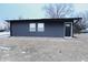 Modern single story home with dark siding and a black front door at 1384 Cross St, Martinsville, IN 46151